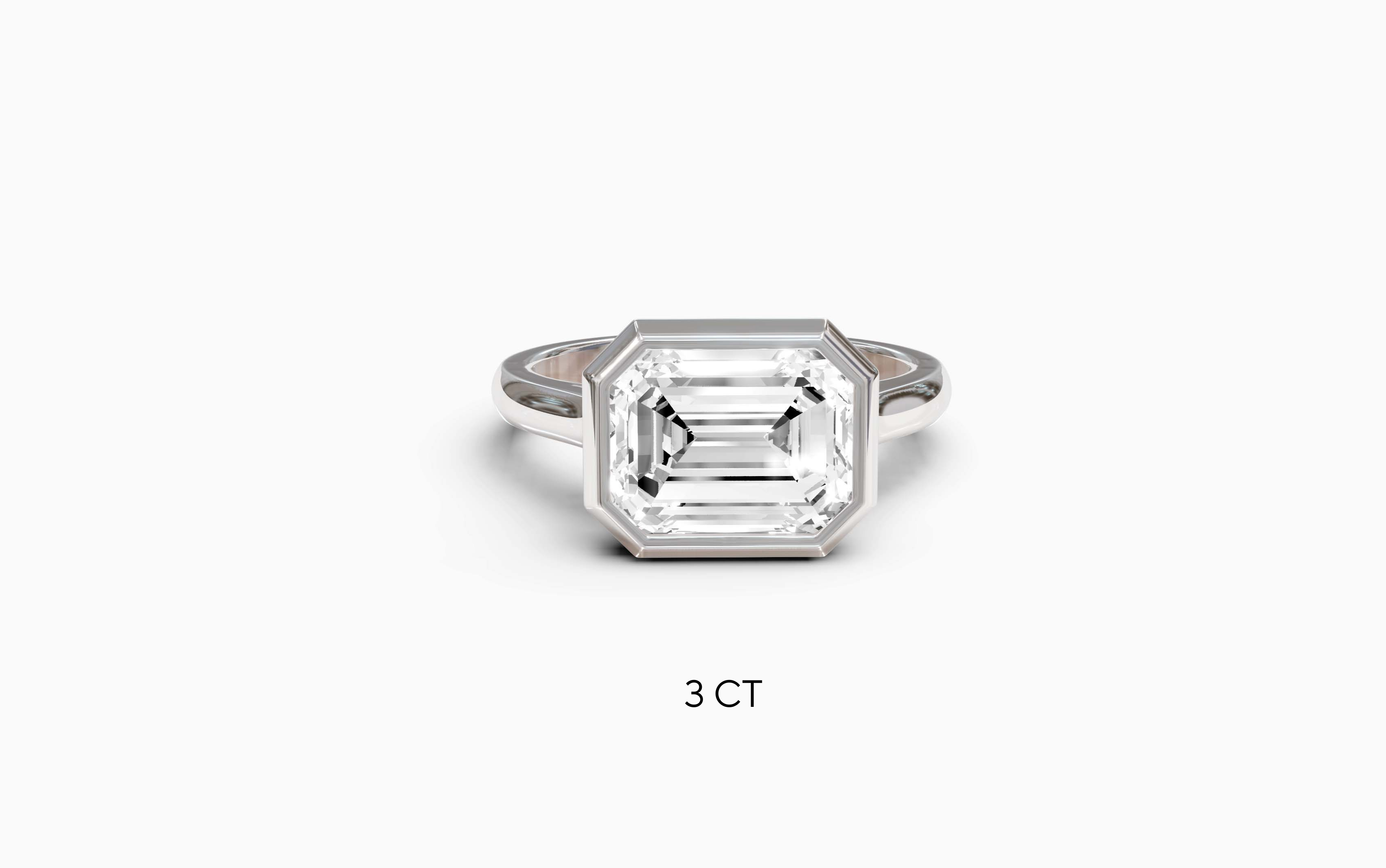 "It Girl" East-West Bezel Emerald Cut Solitaire Ring in White Gold