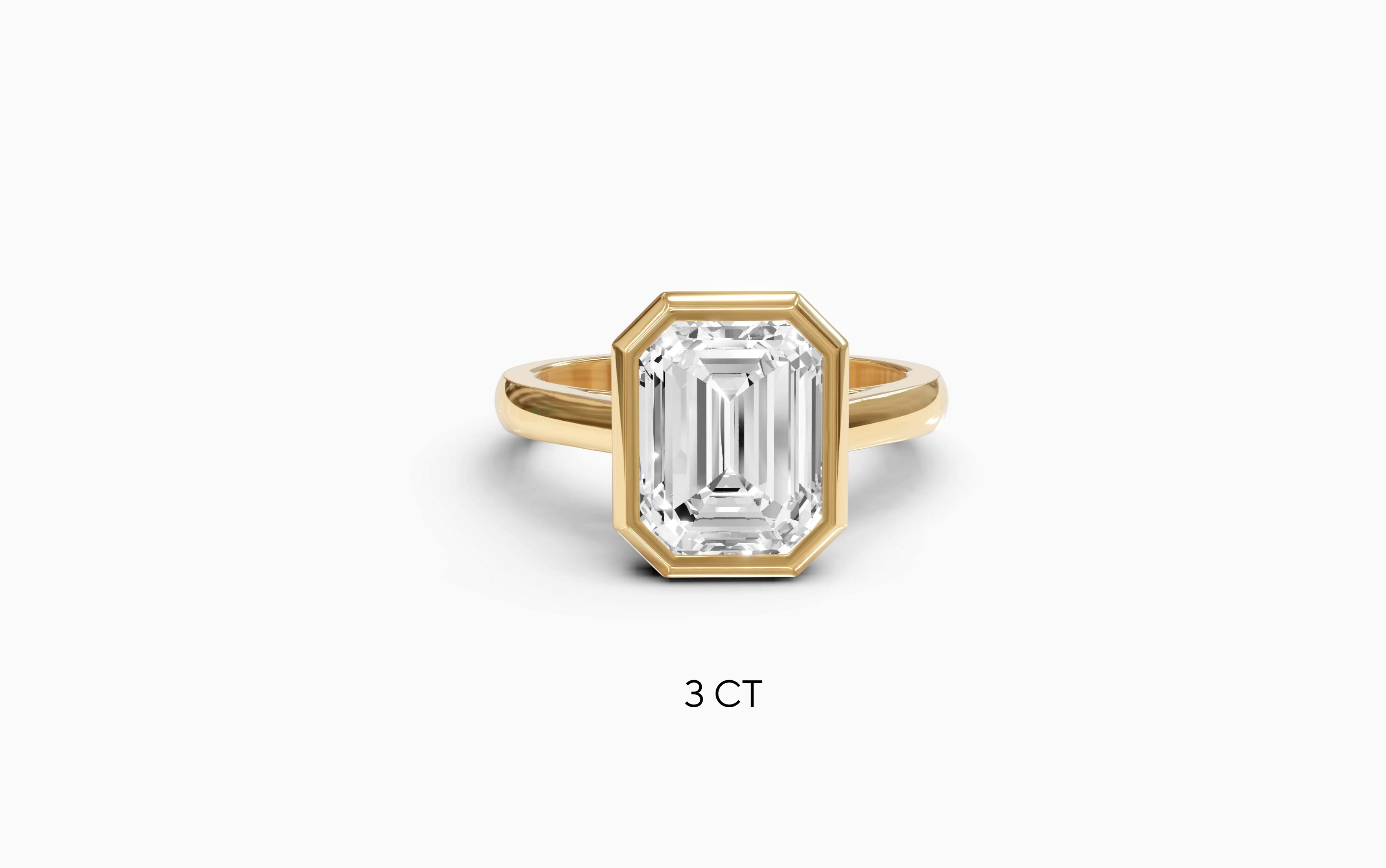"It Girl" Bezel Emerald Cut Solitaire Ring in Yellow Gold
