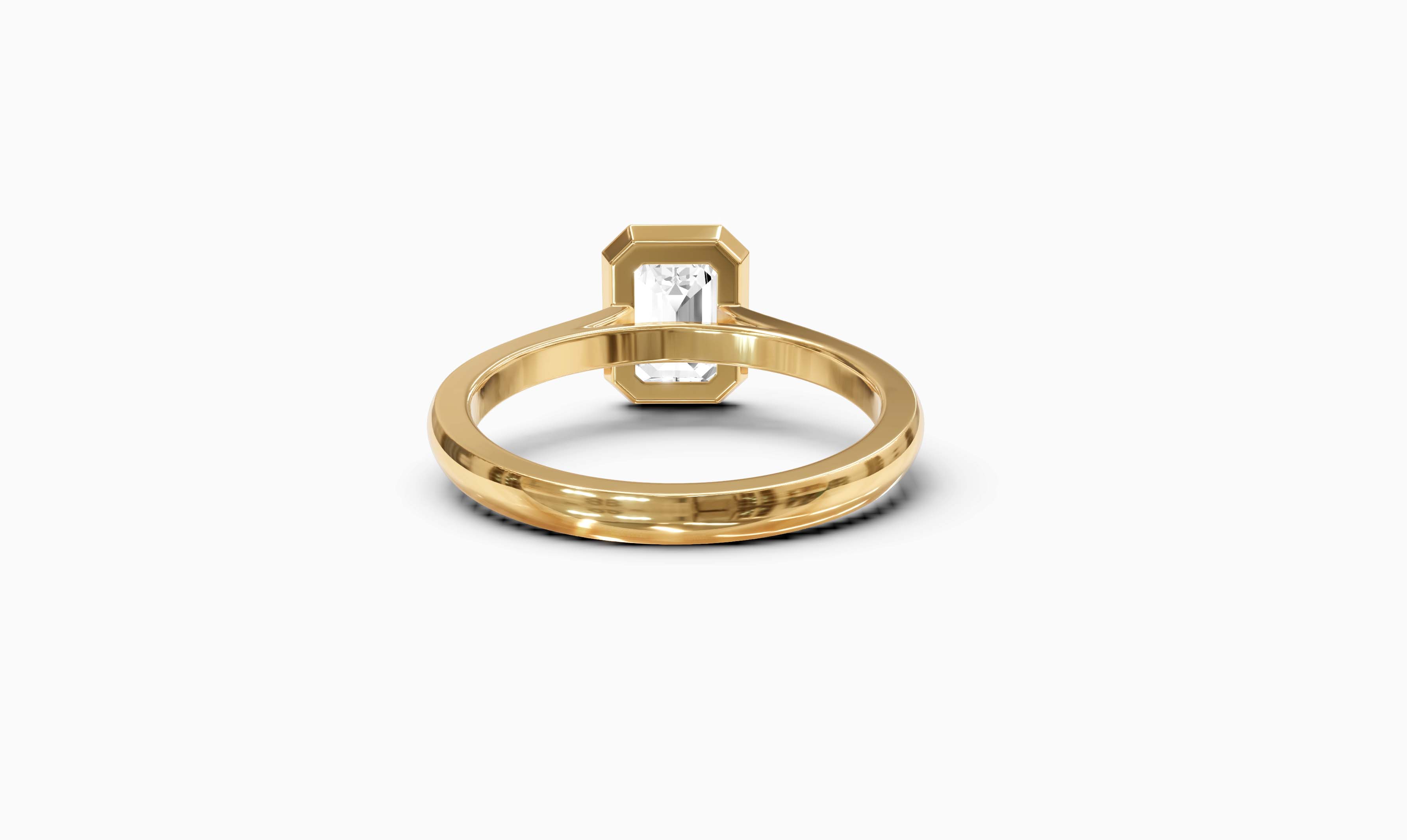 "It Girl" Bezel Emerald Cut Solitaire Ring in Yellow Gold