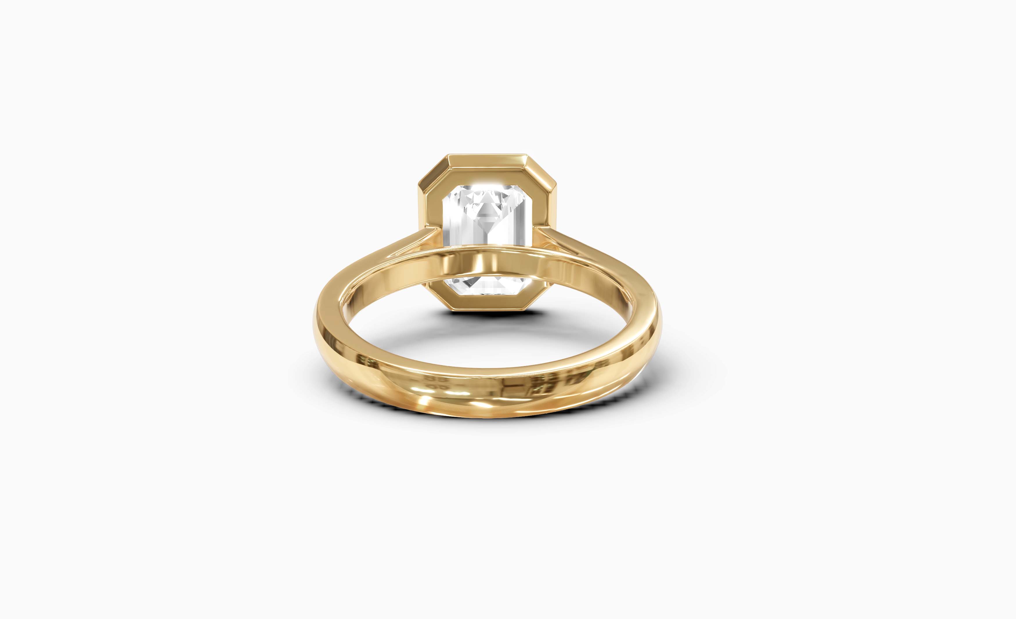 "It Girl" Bezel Emerald Cut Solitaire Ring in Yellow Gold