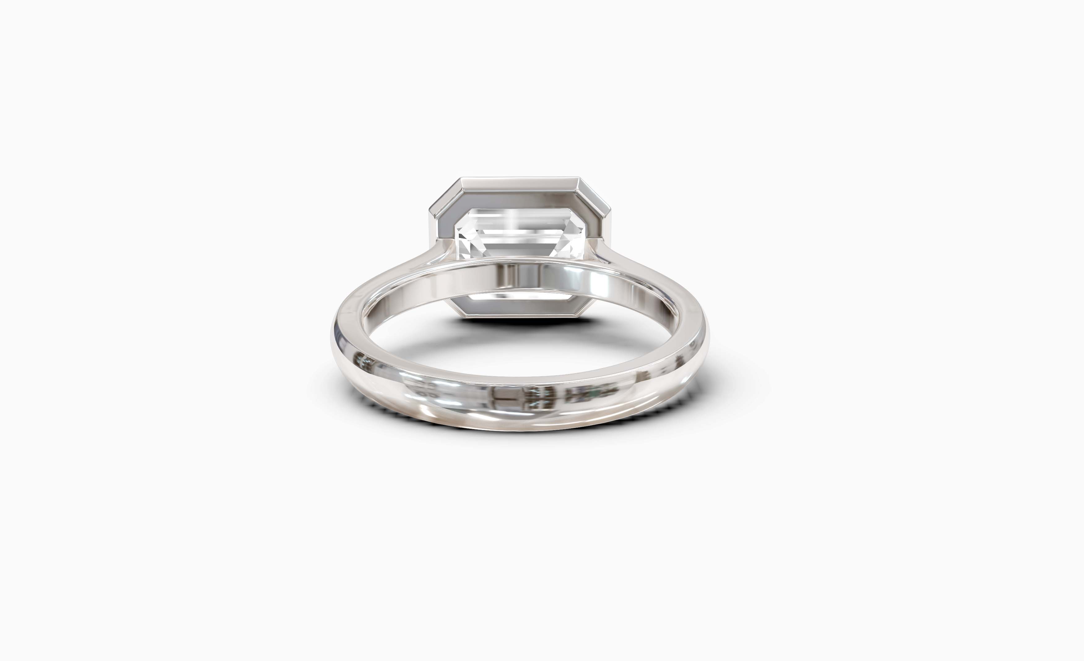 "It Girl" East-West Bezel Emerald Cut Solitaire Ring in White Gold