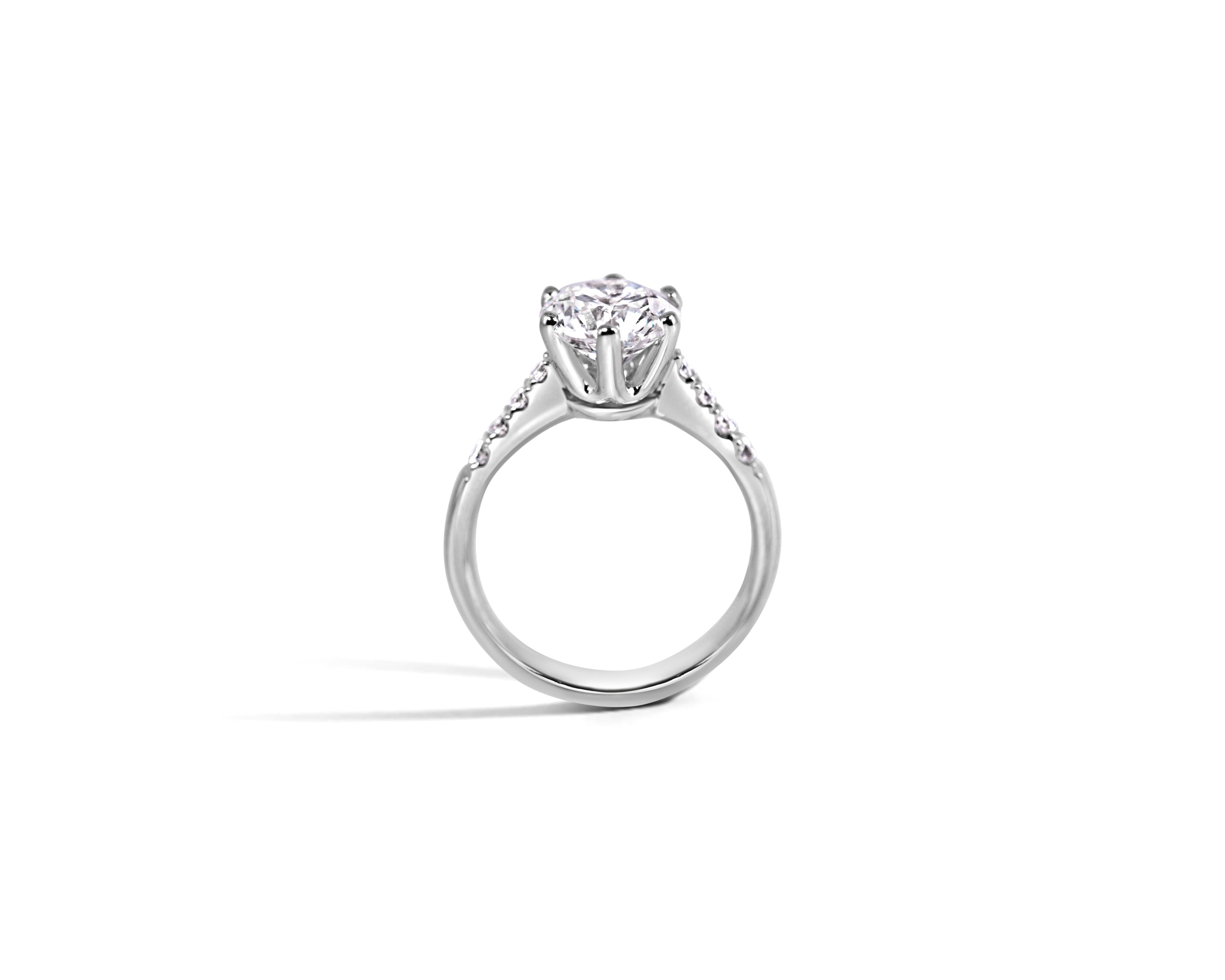 "Fit for a Queen, L" Round Solitaire Ring on Crown Basket with Pavé Band