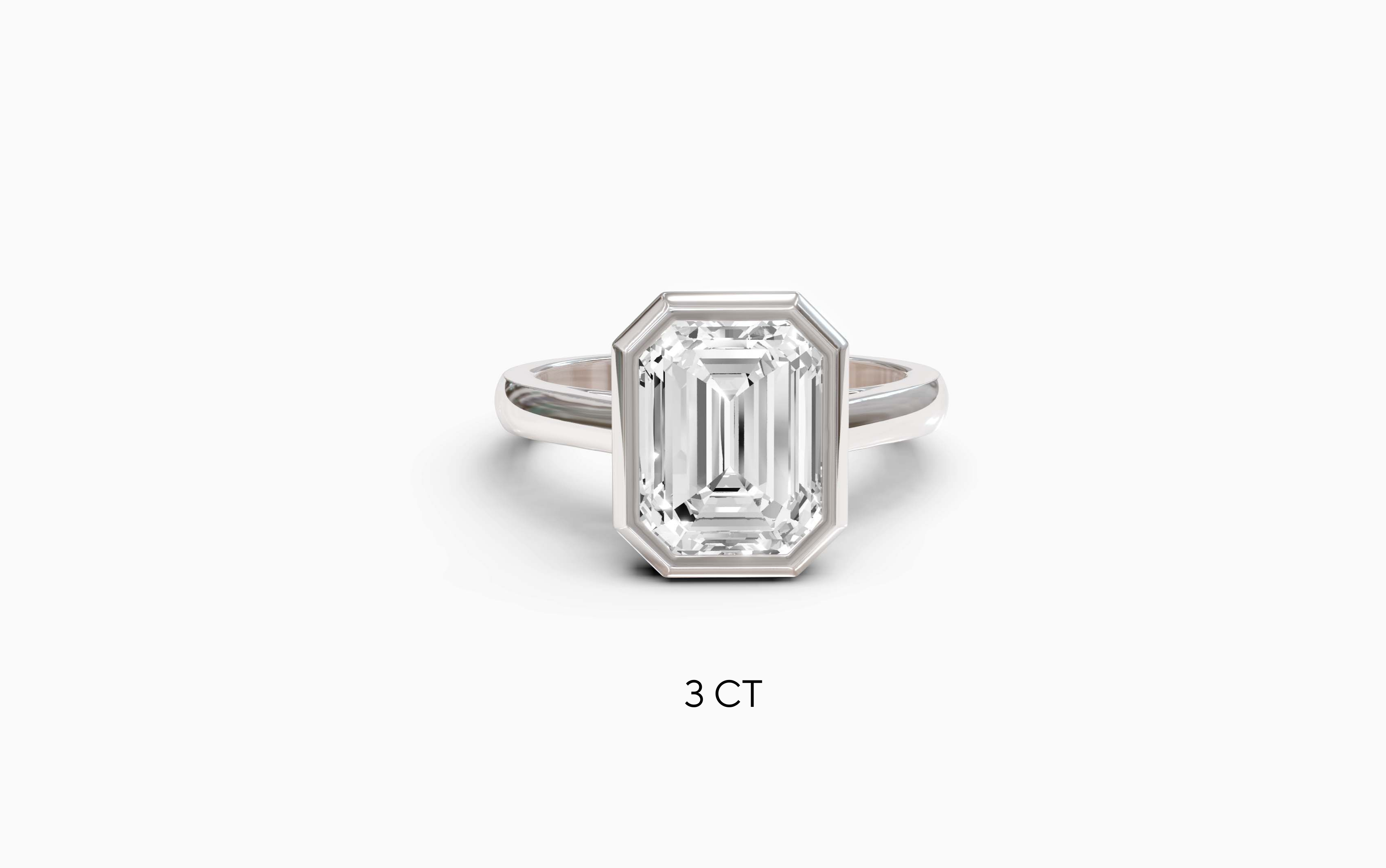 "It Girl" Bezel Emerald Cut Solitaire Ring in White Gold