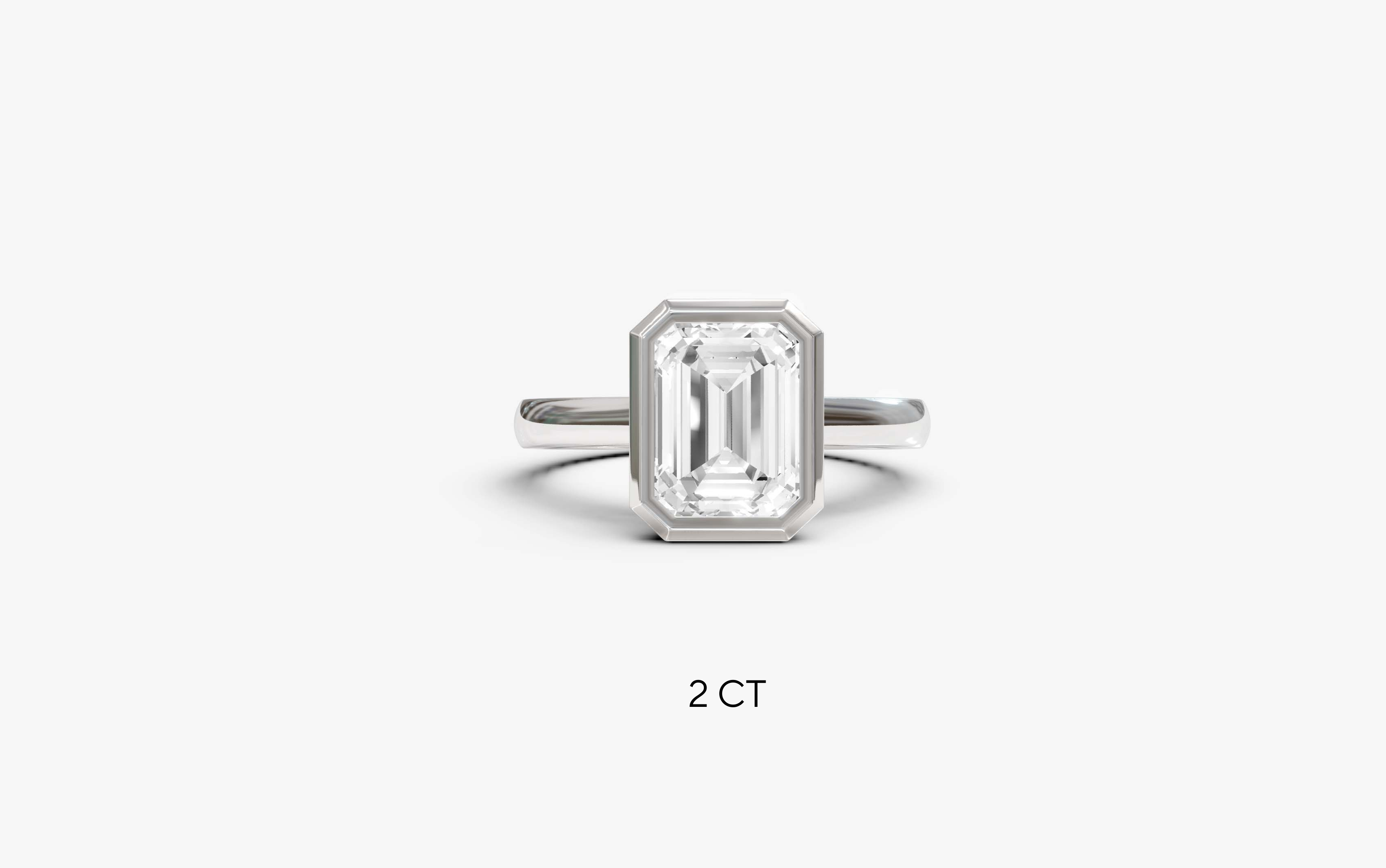 "It Girl" Bezel Emerald Cut Solitaire Ring in White Gold