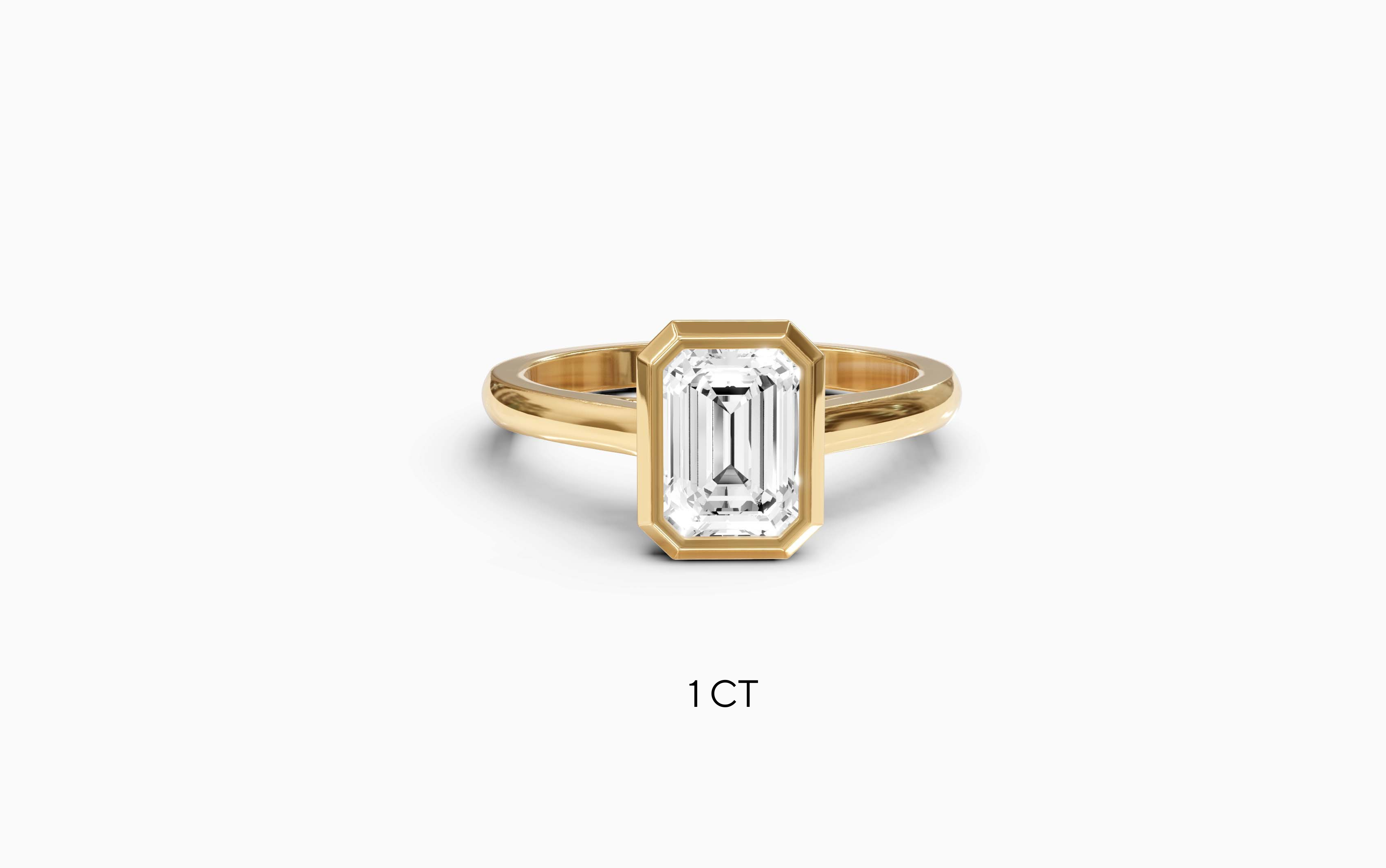 "It Girl" Bezel Emerald Cut Solitaire Ring in Yellow Gold