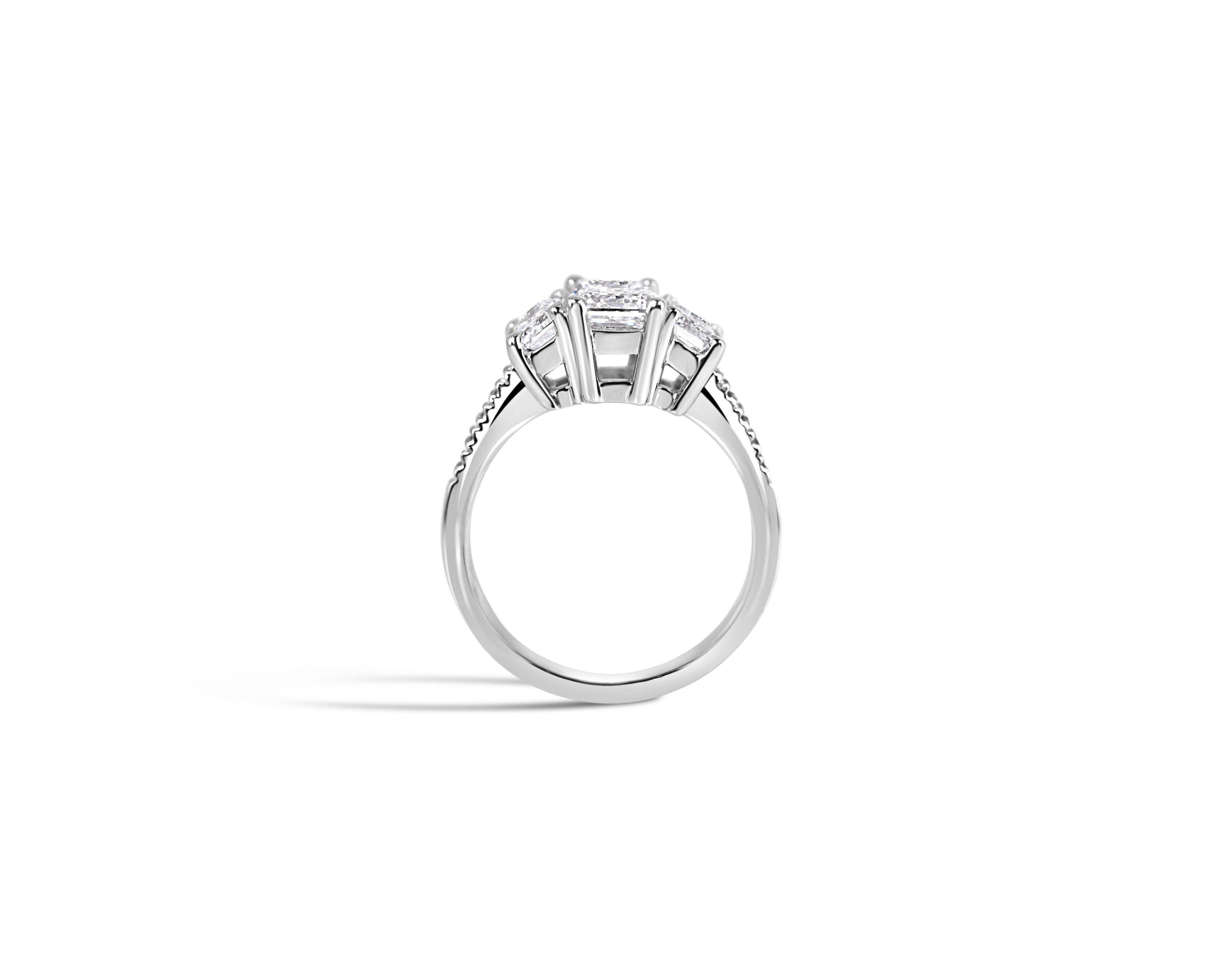 "Everything in Excess" Emerald Cut Three-Stone Ring with Pavé Band