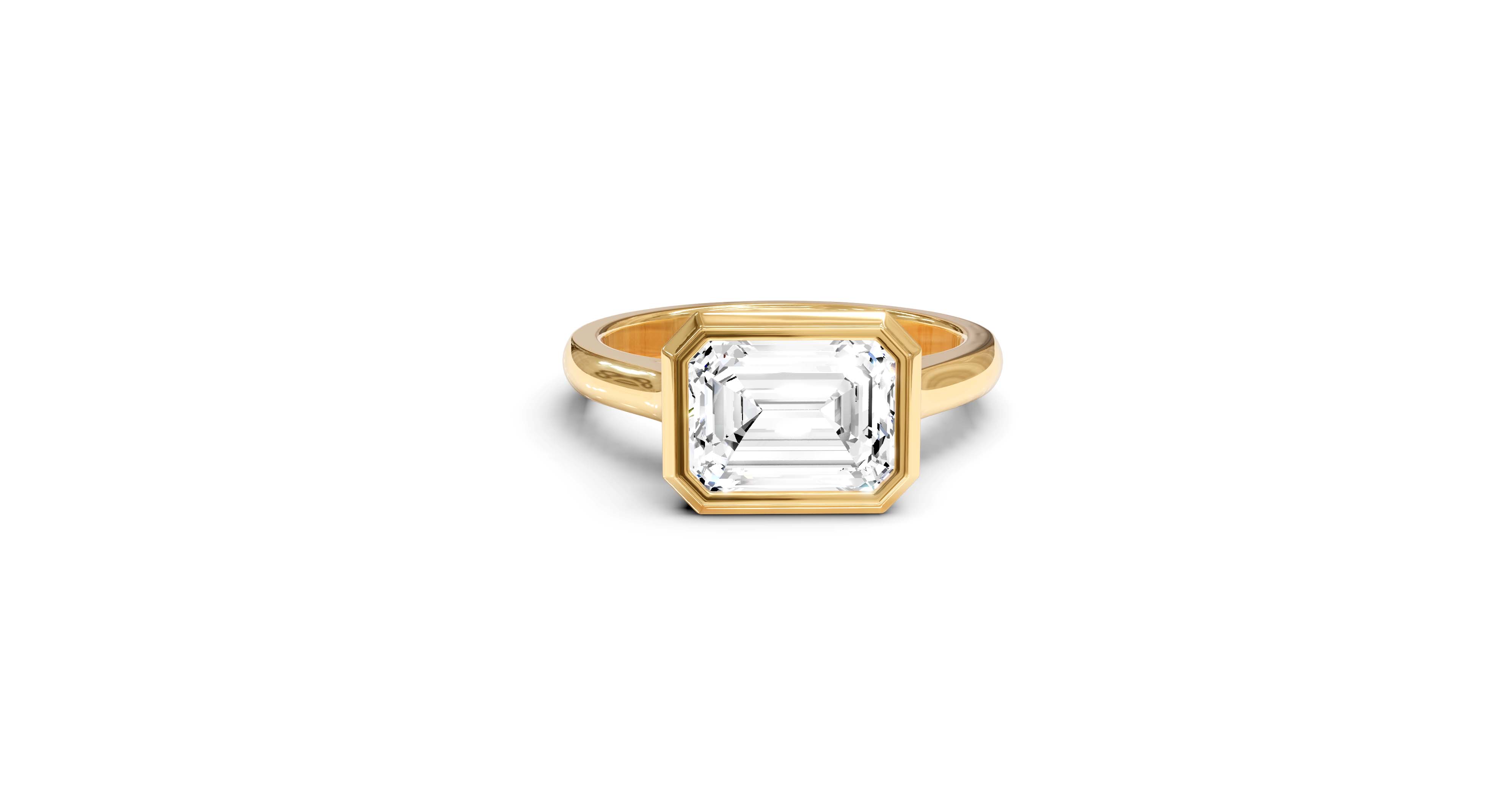 "It Girl" East-West Bezel Emerald Cut Solitaire Ring in Yellow Gold