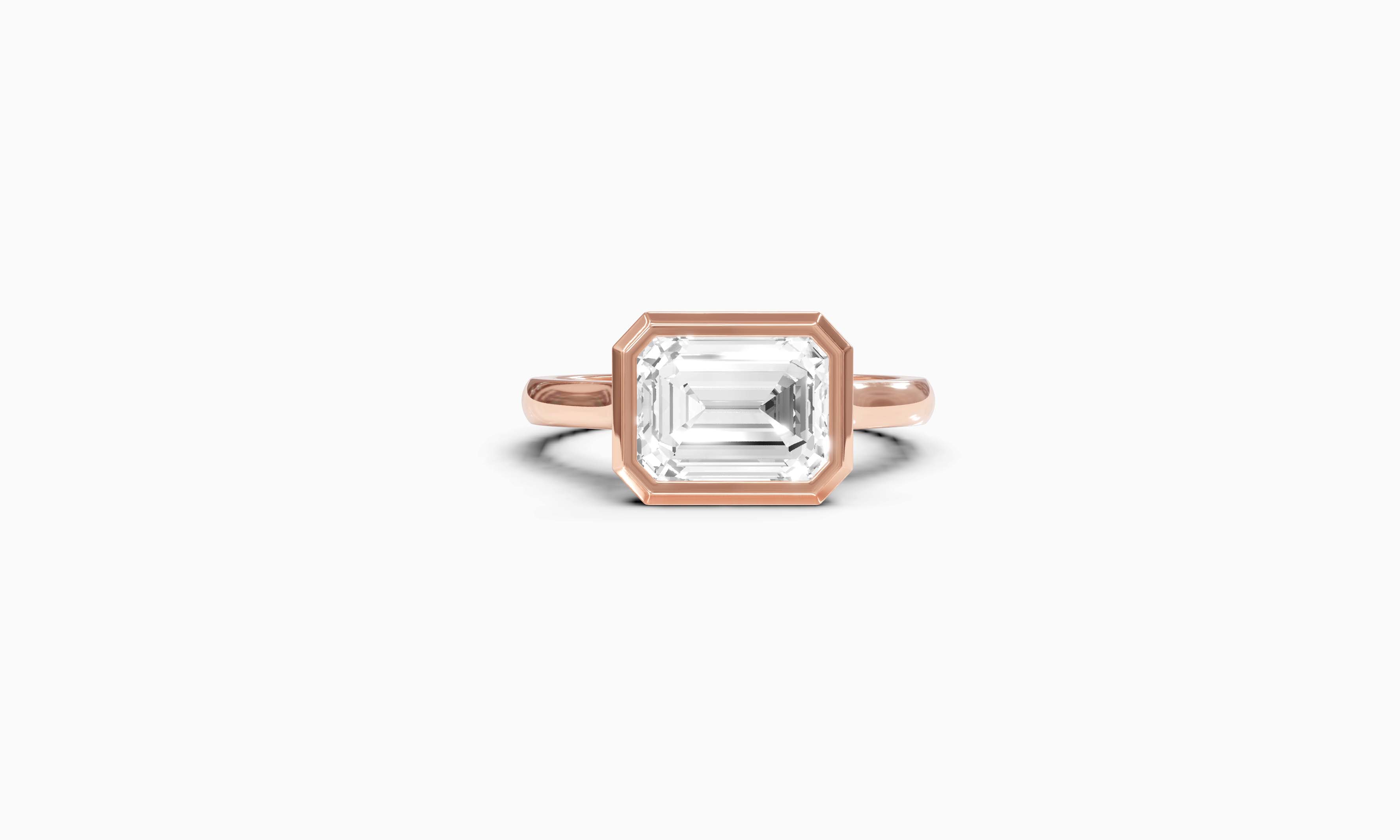 "It Girl" East-West Bezel Emerald Cut Solitaire Ring in Rose Gold